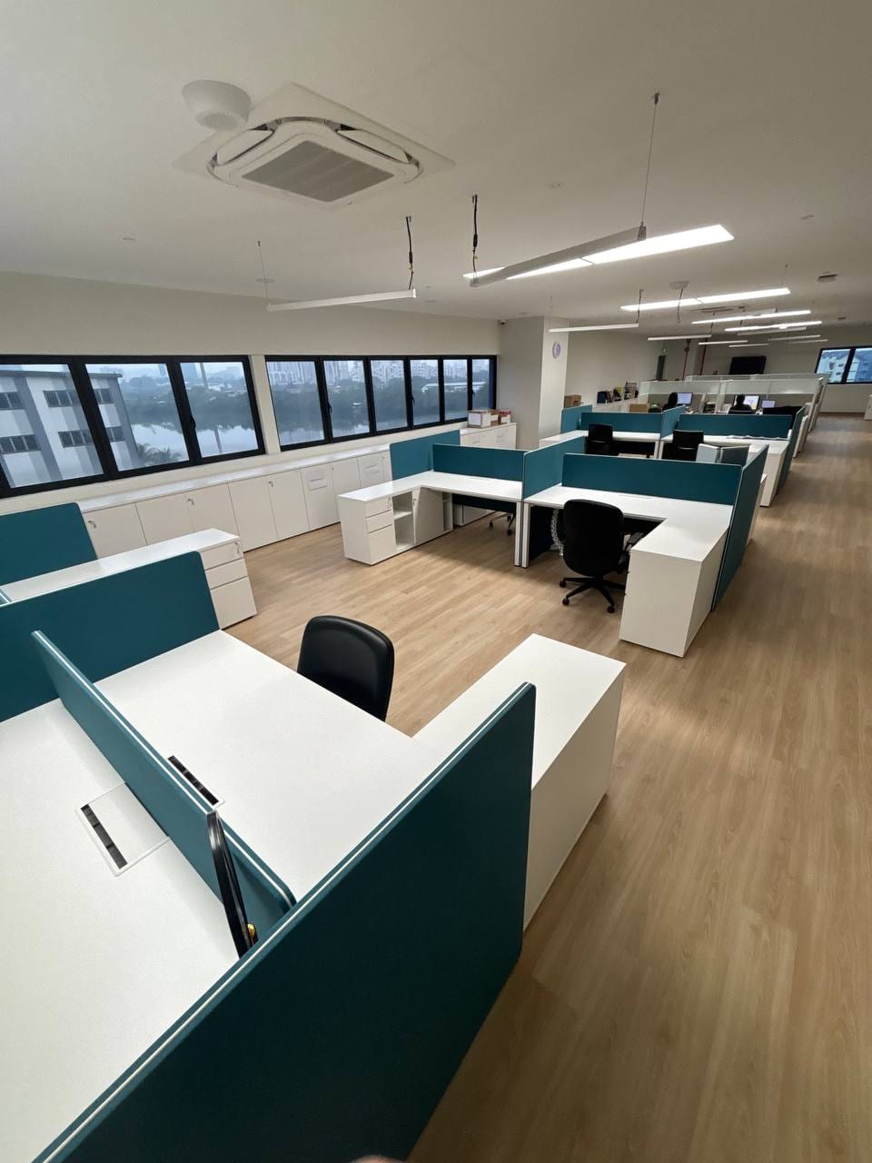 Row of furnished workstations in the existing upper office