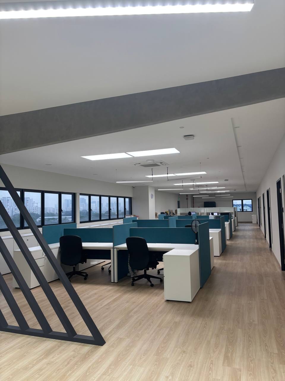 Open plan upper office with a staircase and furnished workstations
