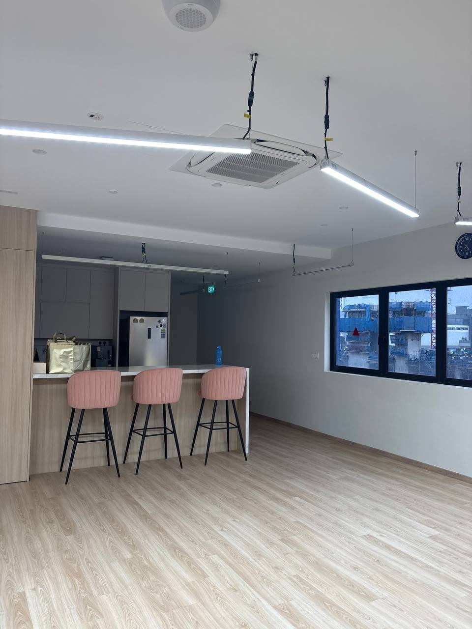 Pantry counter and open wooden floor in the upper office