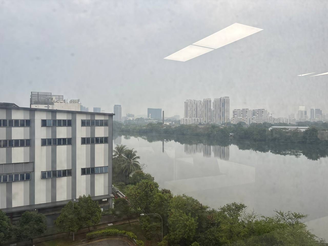Daytime view across the water from the office windows toward Jurong